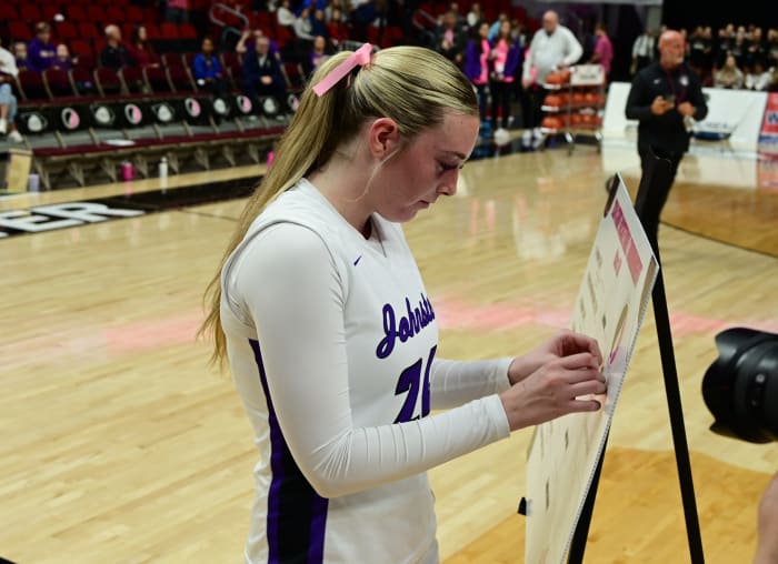 Johnston's Averie Ryan places her team's name plate into the championship round on the Class 5A bracket after Johnston defeated Waukee in the 5A semifinals on Thursday at Wells Fargo Arena in Des Moines. (Photo by Ryan Timmerman)